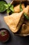 SamosaÂ Snack is an Indian deep fried pastry with a spiced filling usually made with potatoes, spices and herb